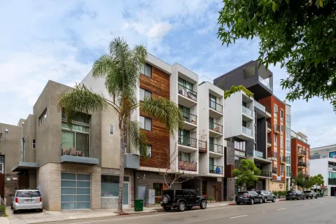 a city street lined with buildings and trees