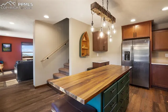 a kitchen with a stove a sink a dining table and chairs