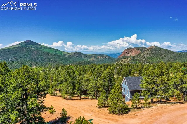 a view of a town with mountains in the background
