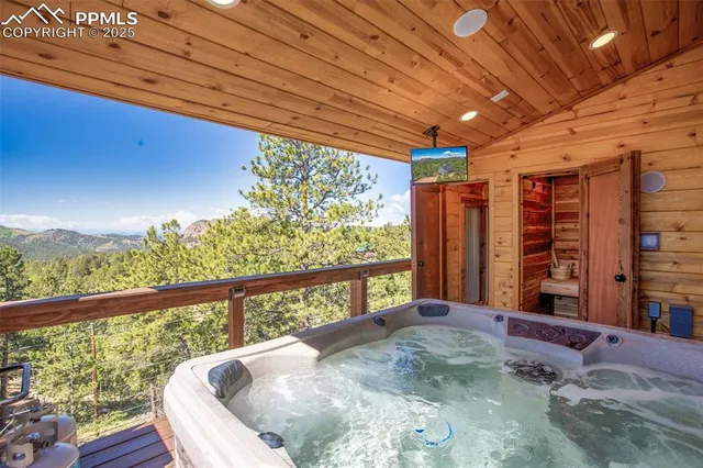 a living room with patio furniture and a floor to ceiling window