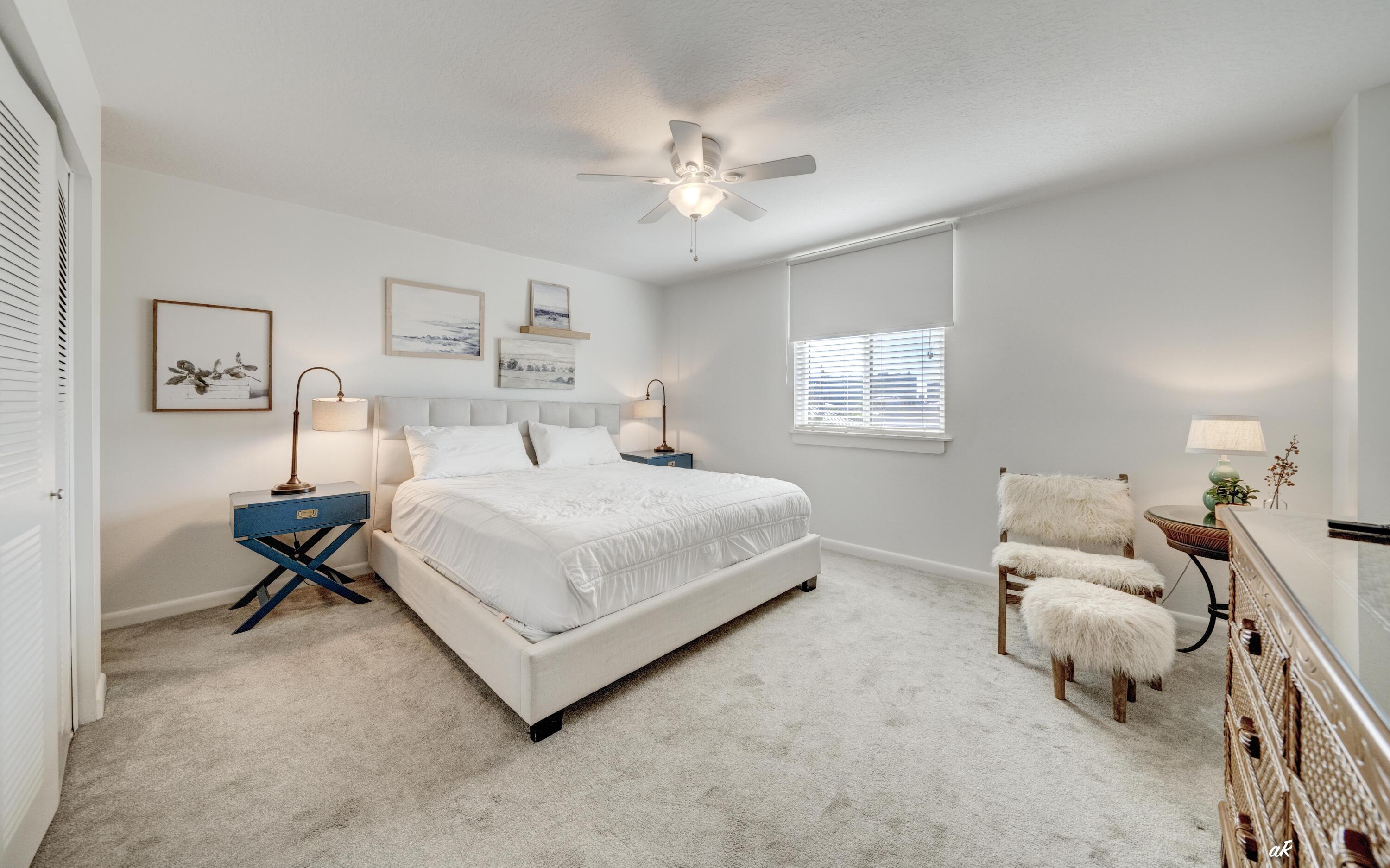 30 Moreno Point Road, Unit 404A Destin, FL 32541 - Photo 19 of 52 a bedroom with a bed and window