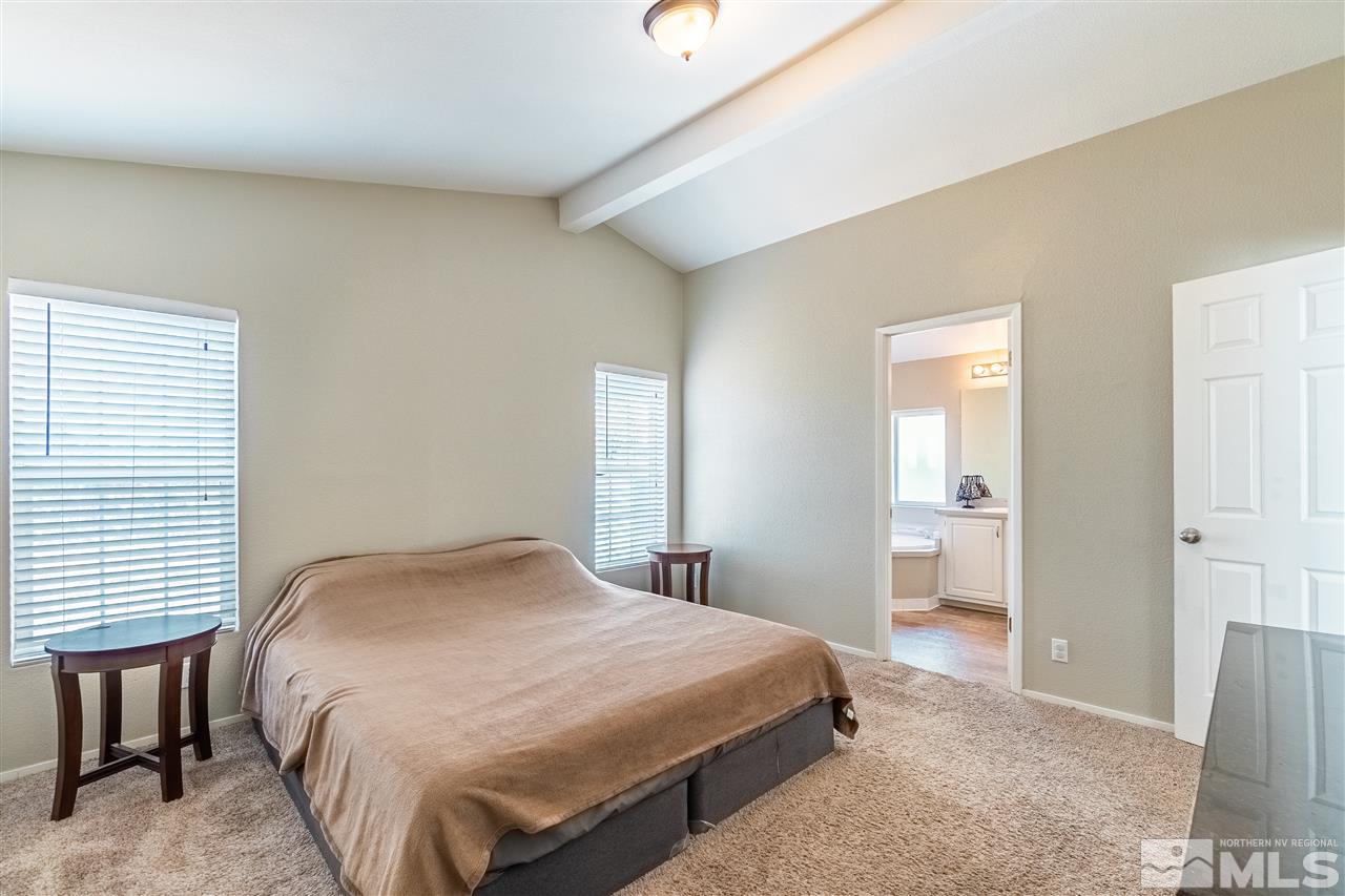1298 Leopard Street Reno, NV 89506 - Photo 11 of 16 a bedroom with a bed and a table
