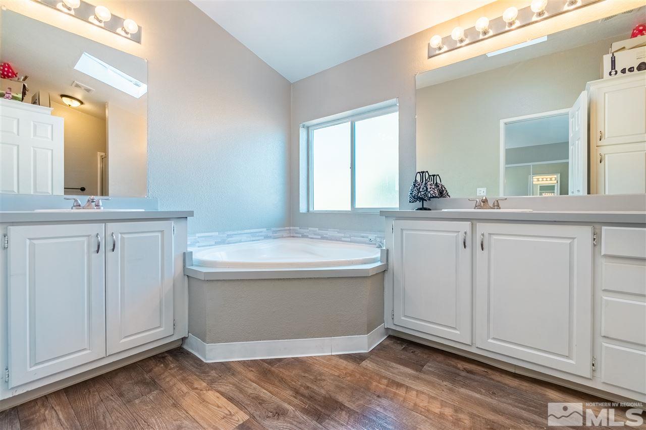 1298 Leopard Street Reno, NV 89506 - Photo 12 of 16 a view of a bathroom with vanity and mirror