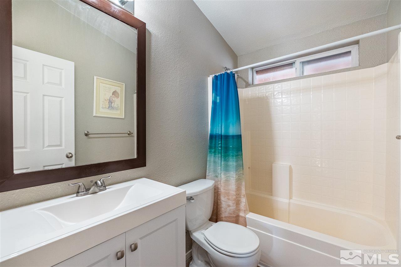 1298 Leopard Street Reno, NV 89506 - Photo 16 of 16 a bathroom with a sink a toilet and shower