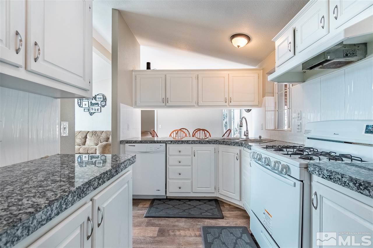 1298 Leopard Street Reno, NV 89506 - Photo 8 of 16 a kitchen with granite countertop cabinets stainless steel appliances and a counter space