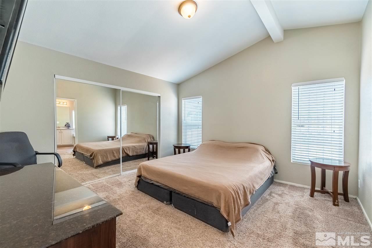 1298 Leopard Street Reno, NV 89506 - Photo 10 of 16 a spacious bedroom with a bed and couch