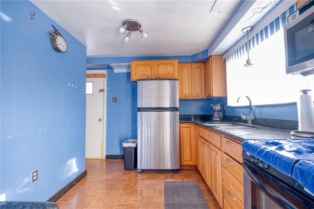 918 Stock Street Pittsburgh, PA 15207 - Photo 4 of 20 a kitchen with stainless steel appliances granite countertop a refrigerator and a sink