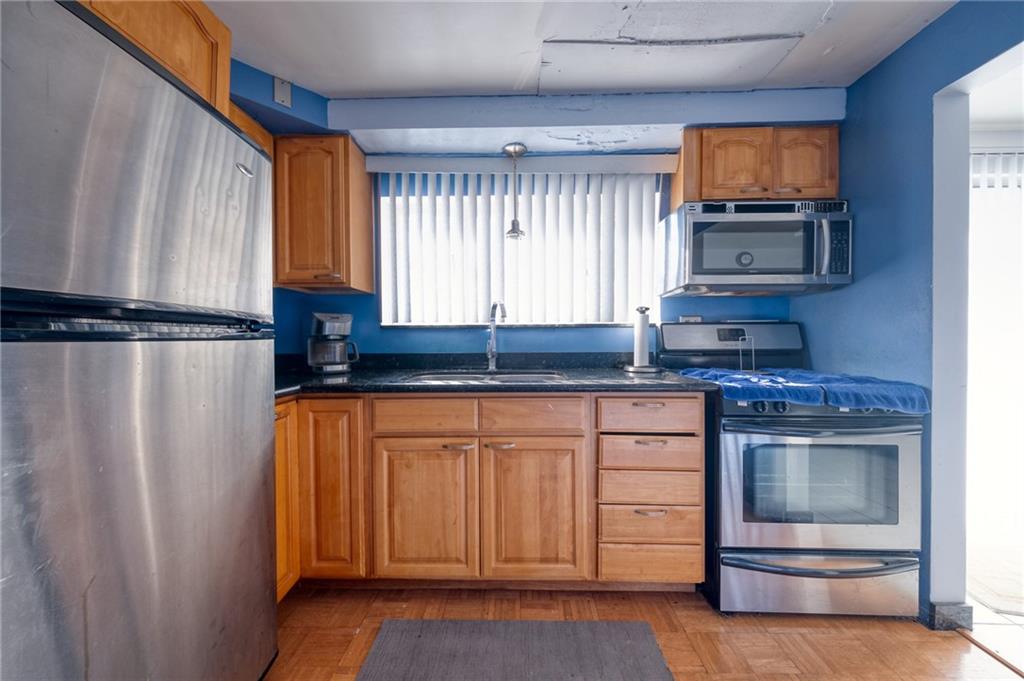 918 Stock Street Pittsburgh, PA 15207 - Photo 5 of 20 a kitchen with stainless steel appliances granite countertop a refrigerator and a stove