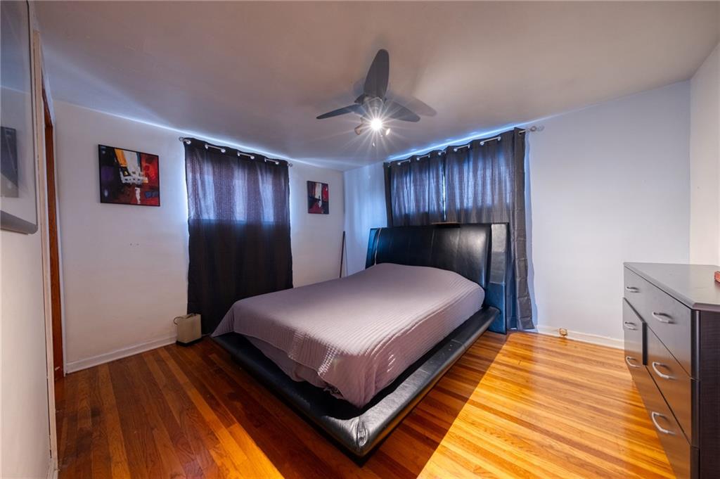 918 Stock Street Pittsburgh, PA 15207 - Photo 7 of 20 a spacious bedroom with a bed and wooden floor
