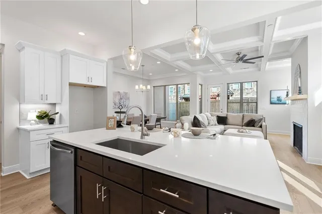 a kitchen with kitchen island a sink appliances and a counter top space