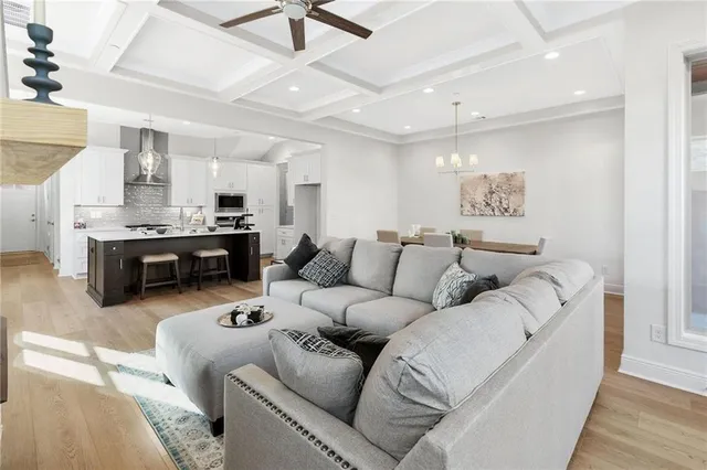 a living room with furniture kitchen view and a fireplace