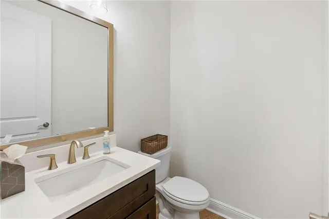 a bathroom with a sink a toilet and mirror