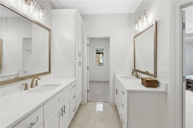 a bathroom with a double vanity sink a mirror and a shower