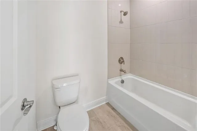 a bathroom with a toilet and bathtub