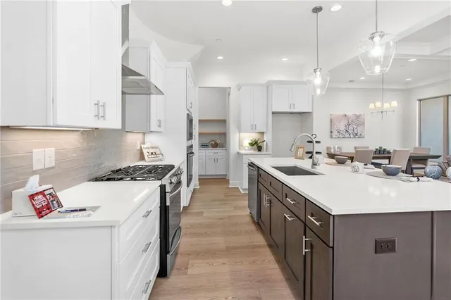 a kitchen with kitchen island a sink a stove and a refrigerator