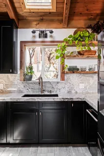 a kitchen with stainless steel appliances granite countertop a sink and a stove
