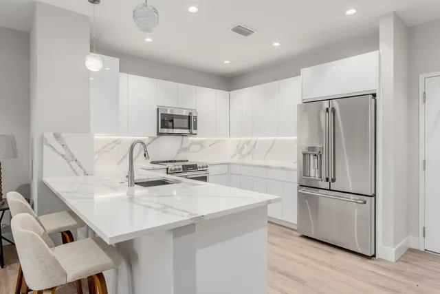 a kitchen with a sink appliances and cabinets