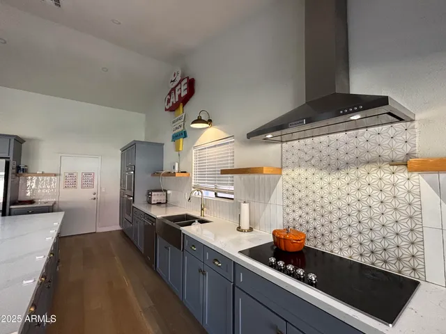 a kitchen with stainless steel appliances kitchen island granite countertop a sink and cabinets