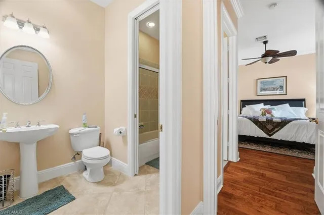a spacious bathroom with a tub sink and mirror