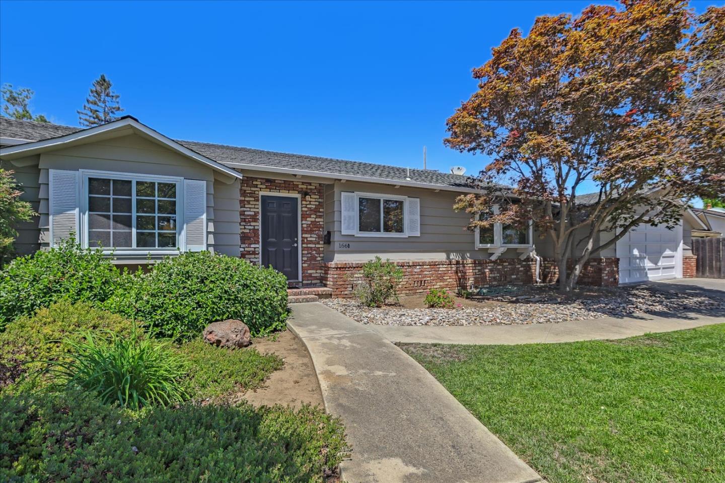 1660 Fordham Way Mountain View, CA 94040 - Photo 2 of 37 a front view of a house with a garden