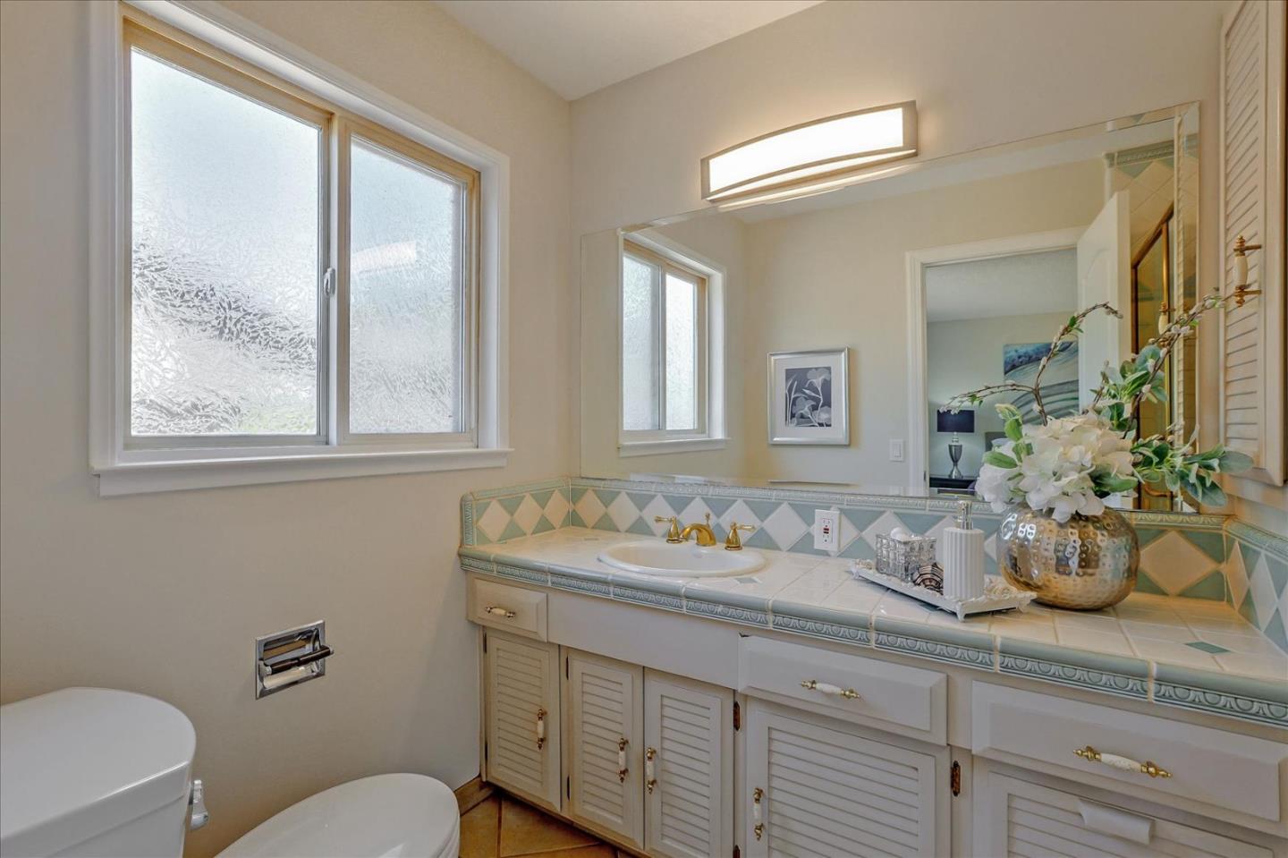 1660 Fordham Way Mountain View, CA 94040 - Photo 31 of 37 a bathroom with a granite countertop sink mirror and next to a window