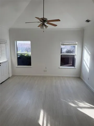 a view of an empty room with a window and closet