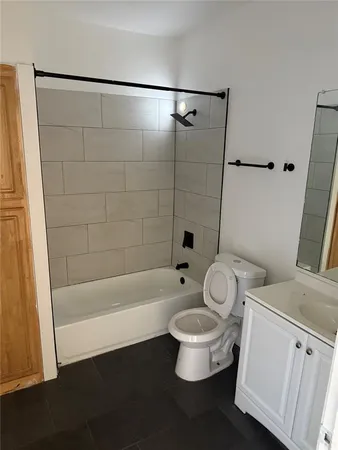 a bathroom with a toilet a sink and a bathtub