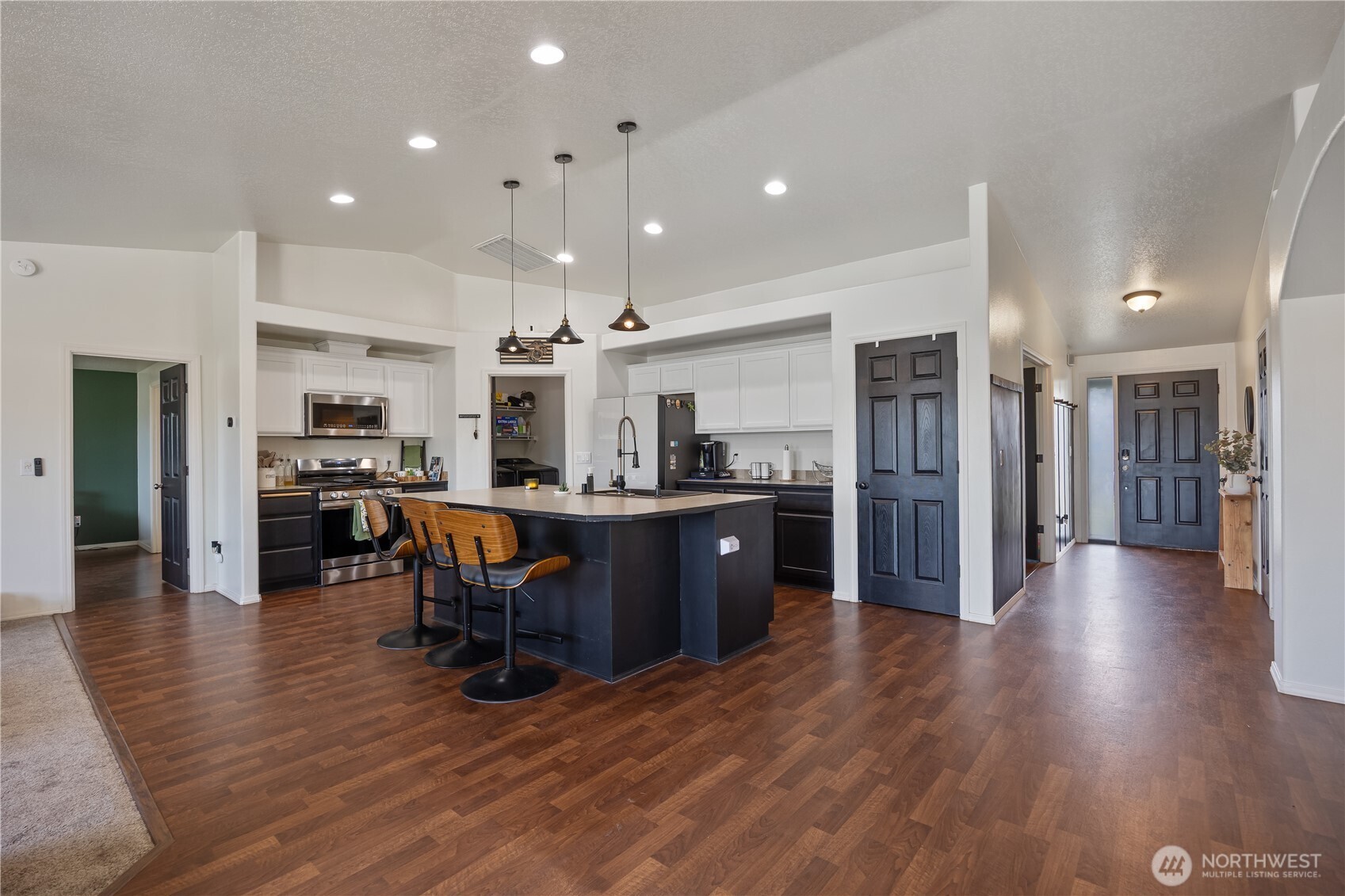 5421 Jackson Lane Pasco, WA 99301 - Photo 14 of 40 a open kitchen with stainless steel appliances granite countertop a refrigerator a sink dishwasher a stove and a dining table with wooden floor