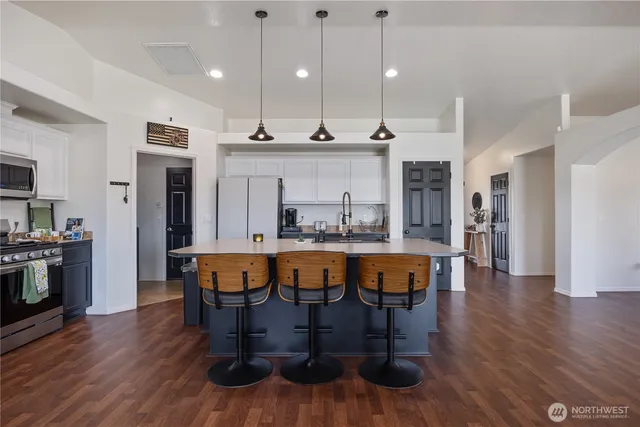 a large kitchen with a table and chairs