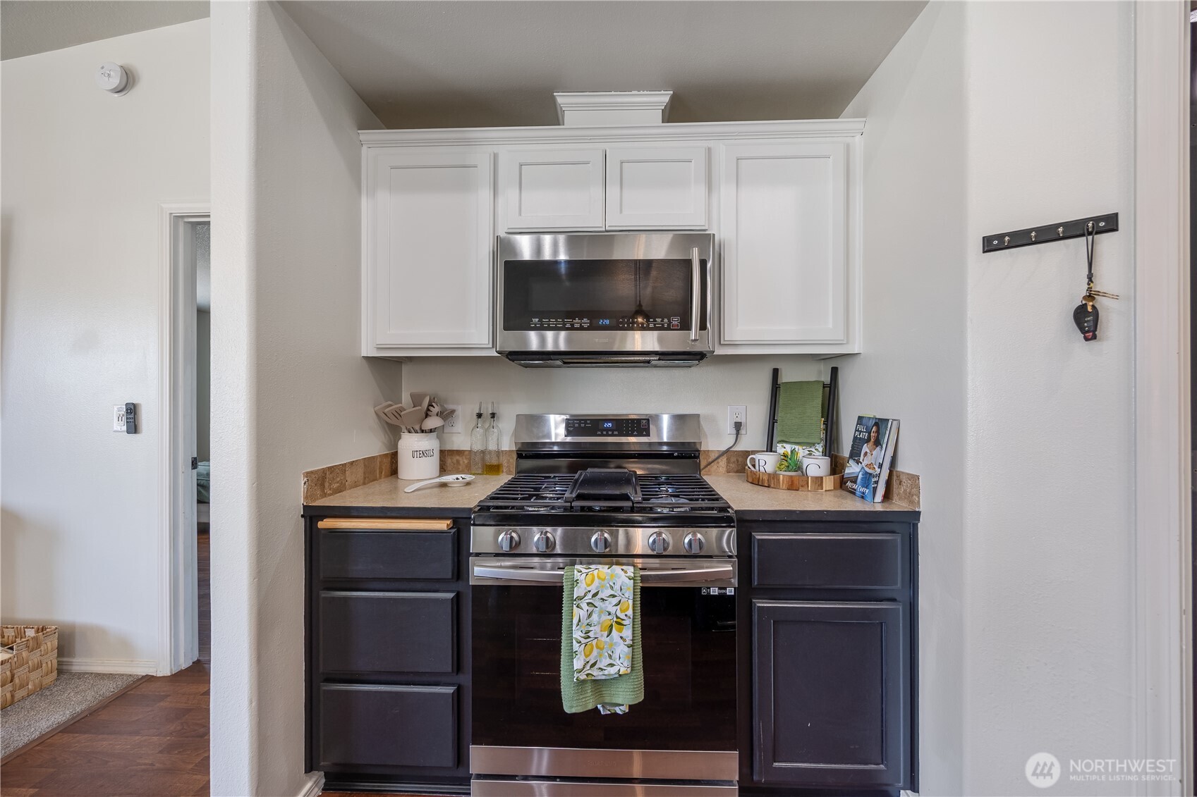 5421 Jackson Lane Pasco, WA 99301 - Photo 16 of 40 a kitchen with stainless steel appliances granite countertop a stove a microwave and a refrigerator