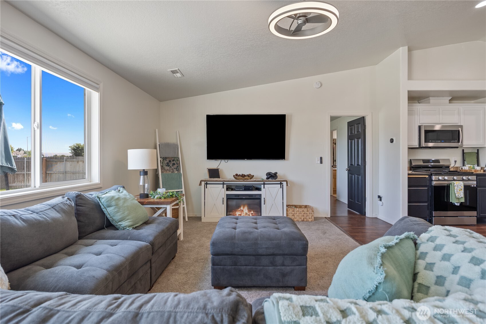 5421 Jackson Lane Pasco, WA 99301 - Photo 22 of 40 a living room with furniture and a flat screen tv