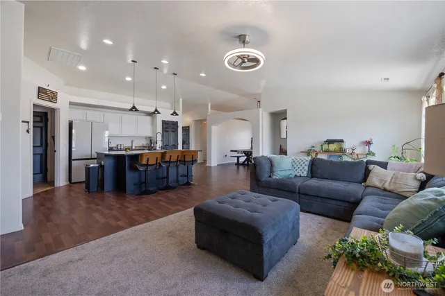 a living room with furniture and kitchen view