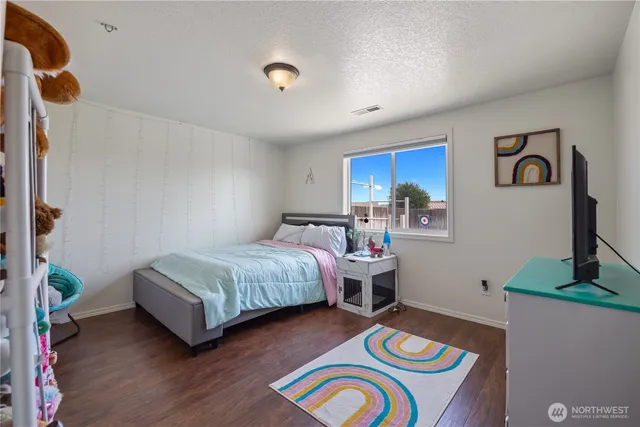 a spacious bedroom with a bed and a desk
