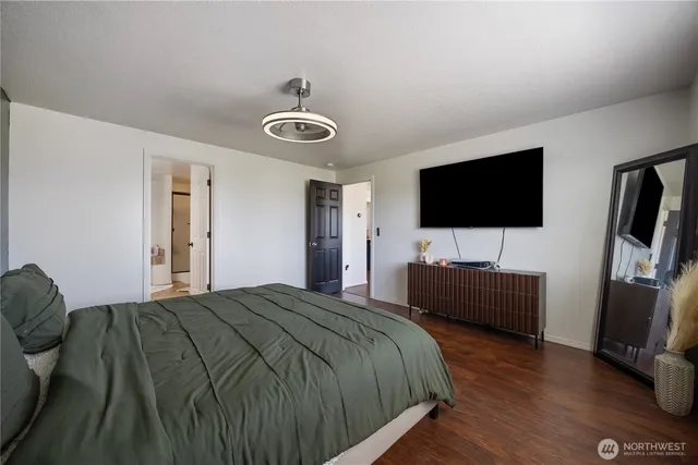 a bedroom with a bed and a flat screen tv