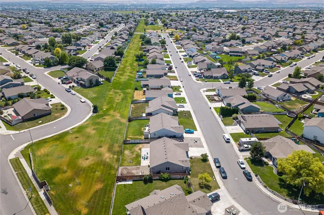 an aerial view of residential houses with outdoor space