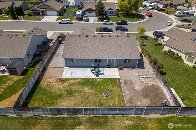 an aerial view of a house with swimming pool and tennis court