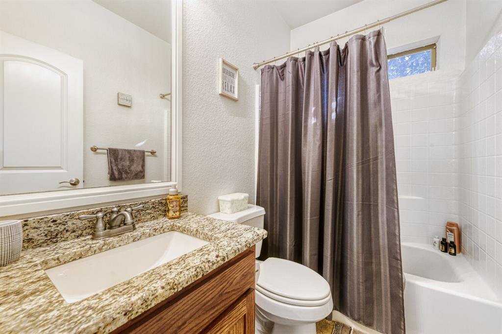 6525 Greenway Road Fort Worth, TX 76116 - Photo 27 of 29 a bathroom with a granite countertop sink and a mirror