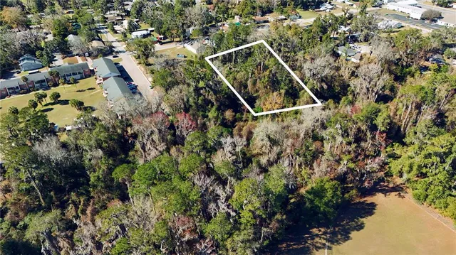 a view of water house with a small yard and large trees