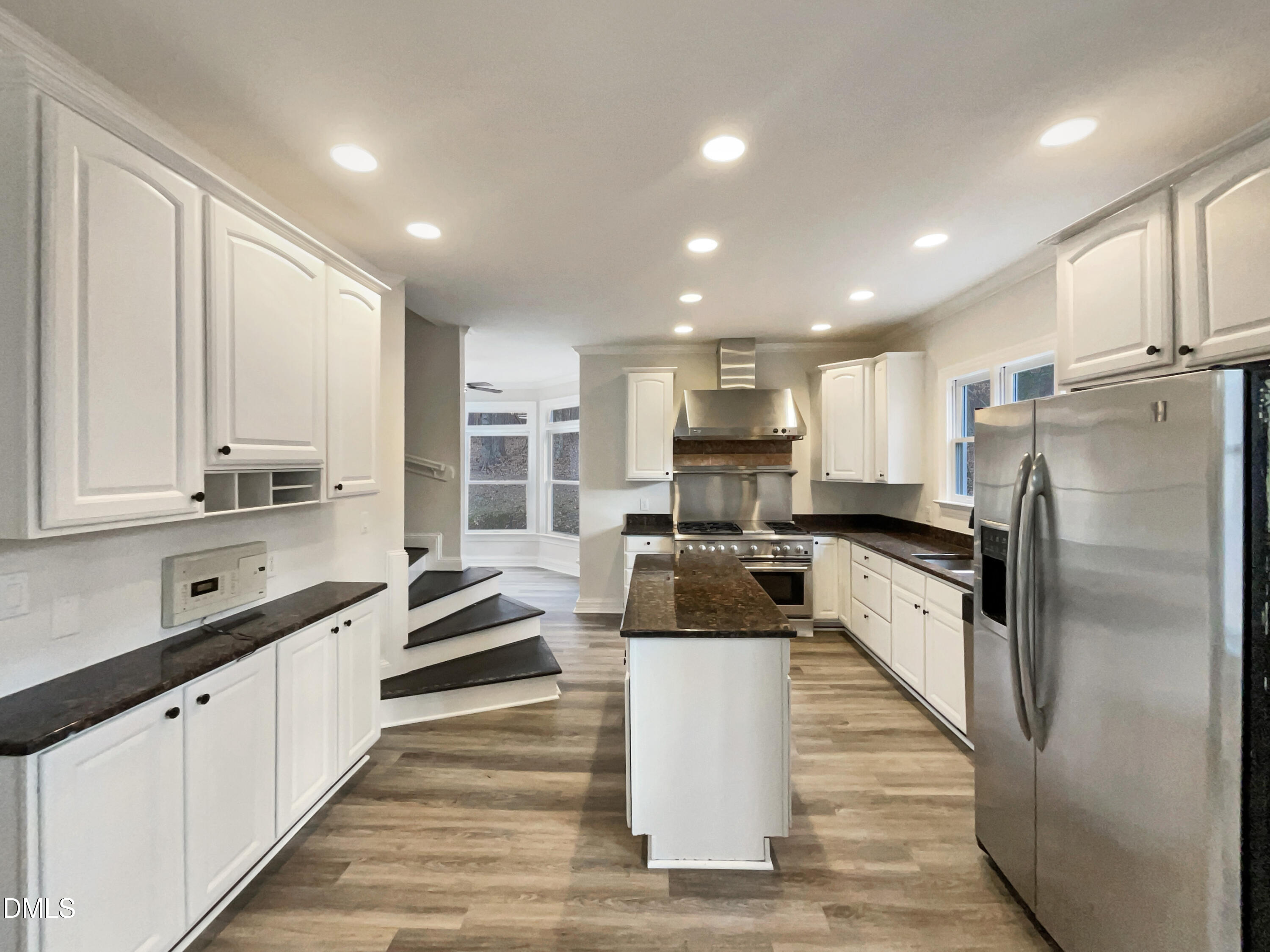 6212 Trevor Court Raleigh, NC 27613 - Photo 2 of 24 a large kitchen with stainless steel appliances and a large window