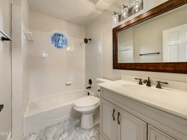 a picture of a bathroom with a shower