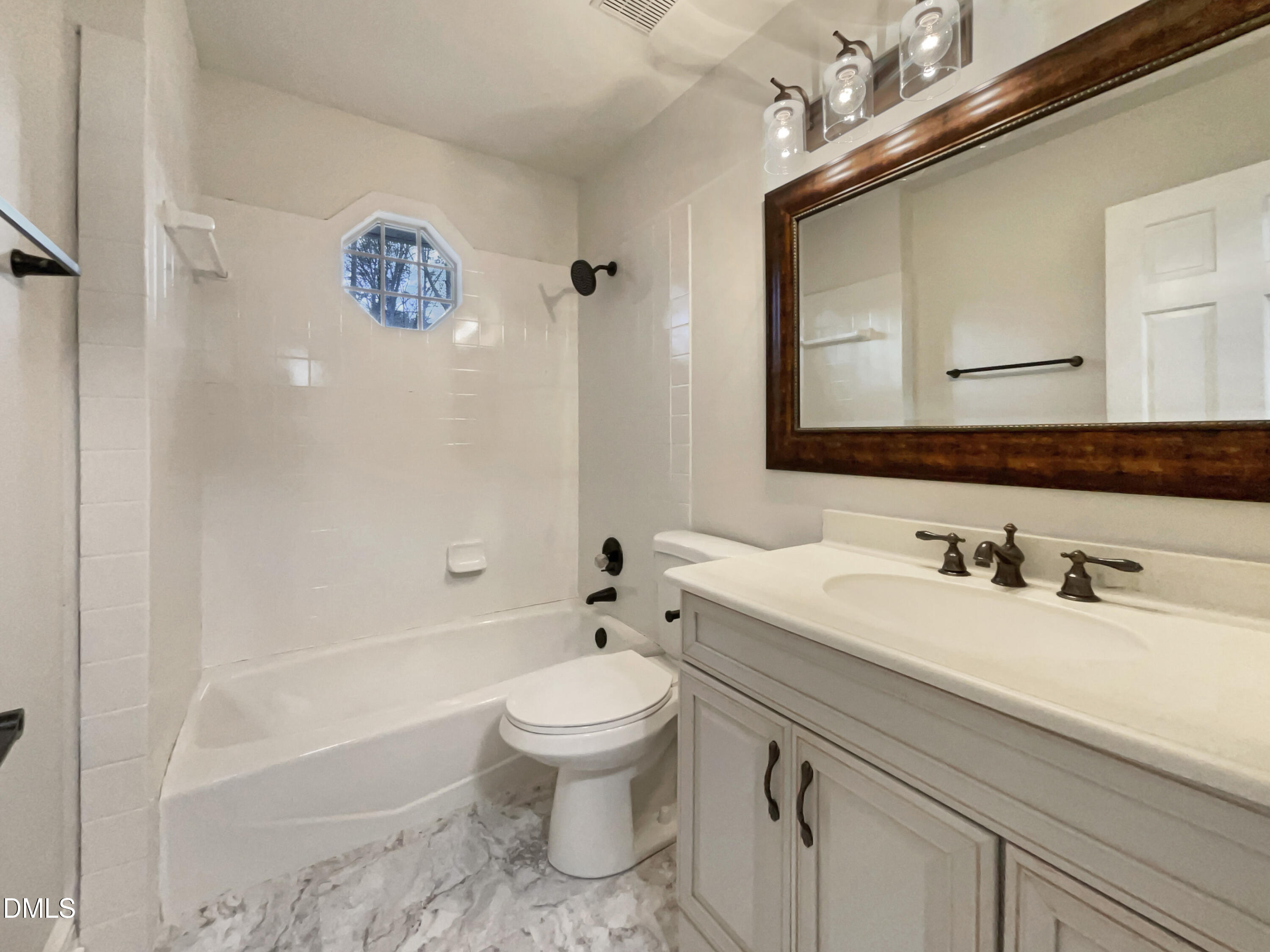 6212 Trevor Court Raleigh, NC 27613 - Photo 23 of 24 a bathroom with a sink a toilet and shower