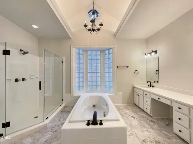 a view of a bathroom with a tub sink and mirror
