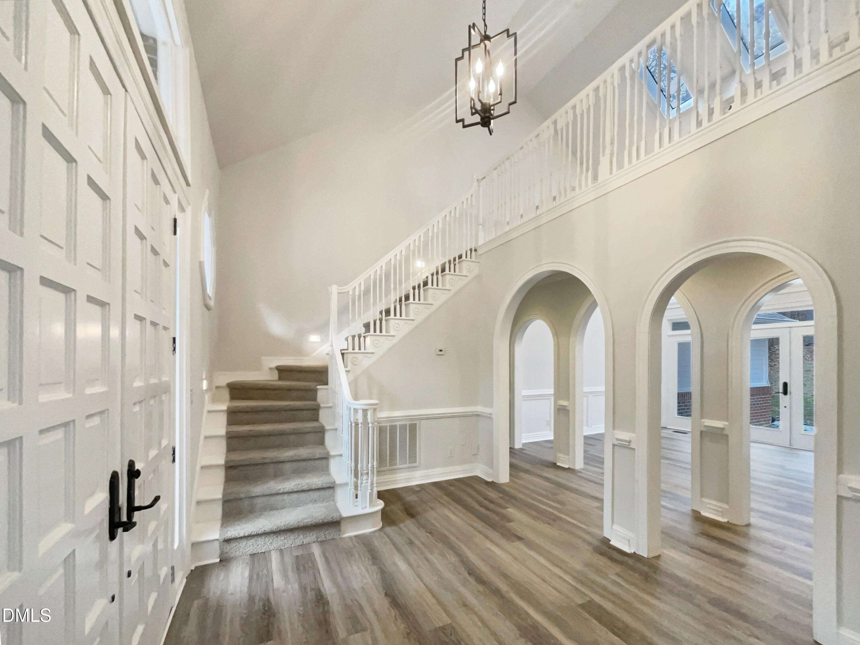 6212 Trevor Court Raleigh, NC 27613 - Photo 7 of 24 a view of entryway and hall with wooden floor