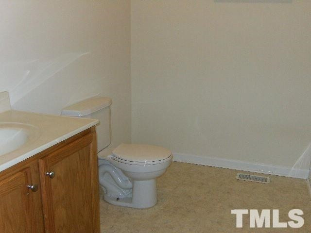 508 Hunter Way Clayton, NC 27520 - Photo 5 of 7 a bathroom with a toilet and a sink