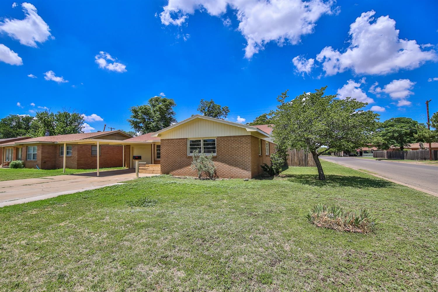 5002 43rd Street Lubbock, TX 79414 - Photo 5 of 10 a front view of a house with a yard and garage
