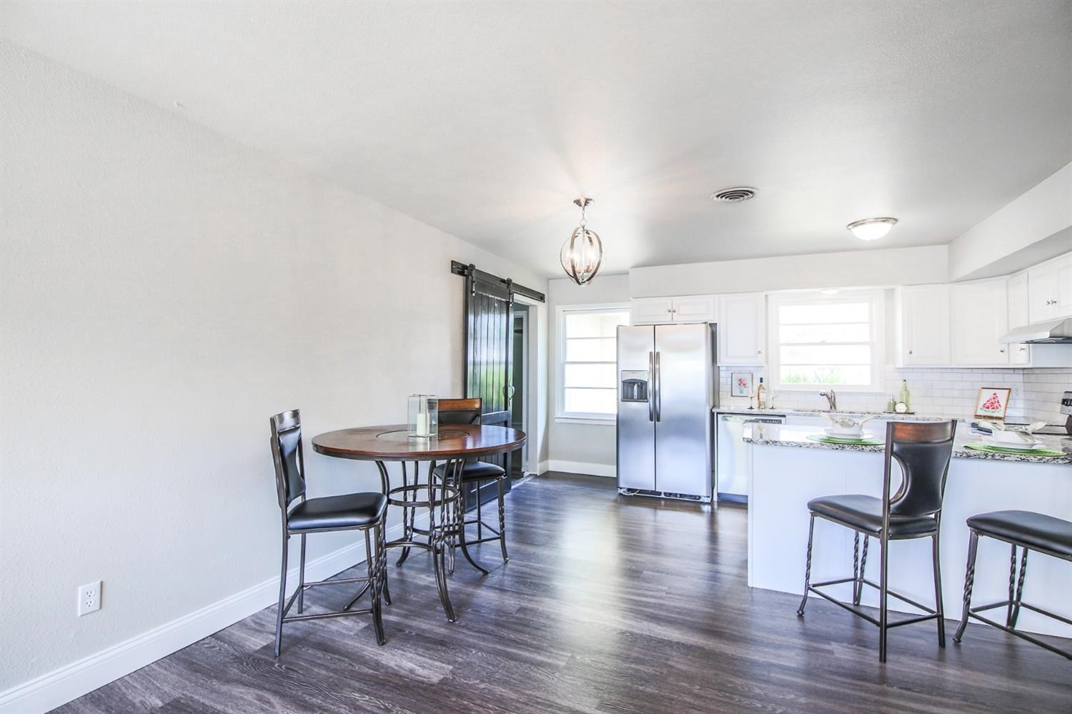 5002 43rd Street Lubbock, TX 79414 - Photo 6 of 10 a view of a dining room with furniture window and wooden floor
