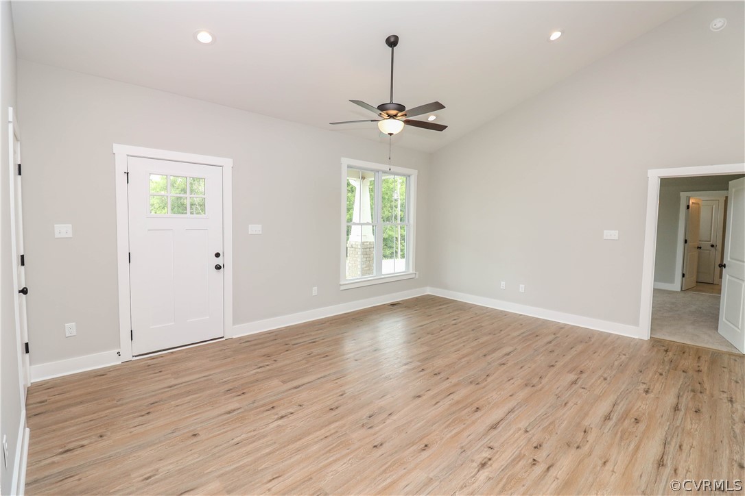 400 Moore Road Farmville, VA 23901 - Photo 11 of 31 an empty room with wooden floor chandelier and windows