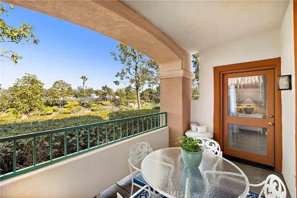a view of a balcony and dining space