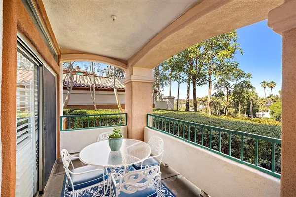 a view of a patio with a table chairs and a backyard