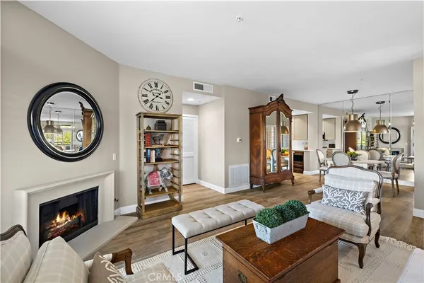 a living room with furniture a fireplace and a wall painting